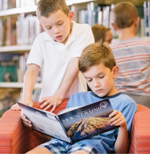 Two kids reading a book