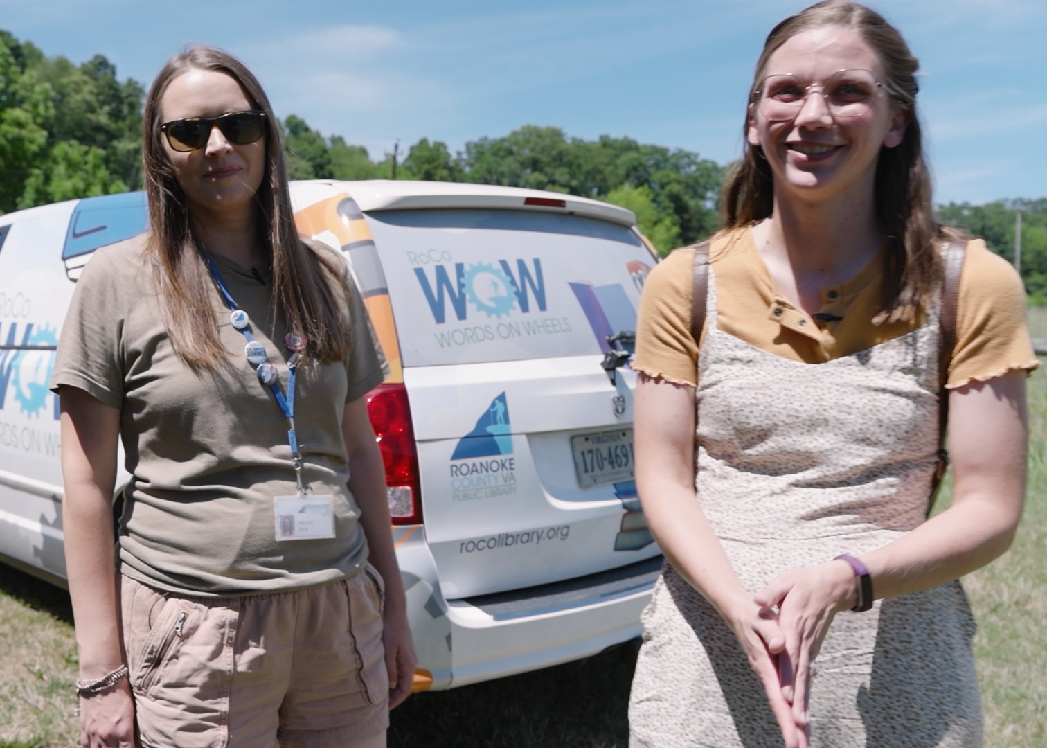 Em Poertner and Allyson Frick stand infront of the bookmobile.