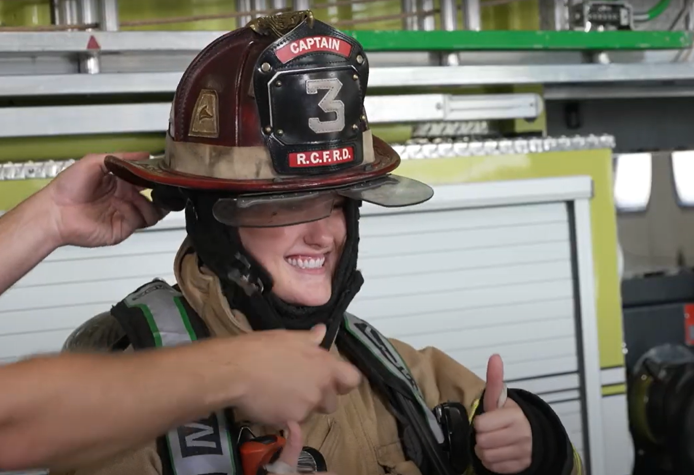 Kaelyn getting fire uniform on